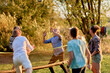 © Flamingo Images - Friends playing volleyball outdoors