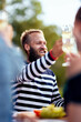 © Flamingo Images - Laughing man toasting friends outdoors