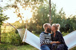 © Flamingo Images - Couple kissing on a hammock
