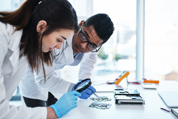 Wall Mural - a tech savvy team to support any it system. a young man and woman repairing computer hardware in a l