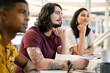 © M Moller/peopleimages.com - Listening keenly to the speaker. a young businessman sitting alongside his colleagues during a presentation in an office.