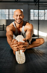 Wall Mural - Working out is for the body and mind. a young man stretching his legs before a workout.