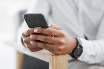 Wall Mural - Lets see what landed in my inbox. Closeup shot of an unrecognisable businessman using a cellphone in an office.