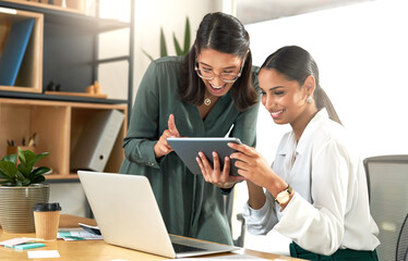 Canvas Print - Look at this its hilarious. two businesswomen using a digital tablet to oversee work.