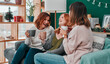 © N F/peopleimages.com - The gift of friendship. three attractive women having a coffee on the sofa together at home.