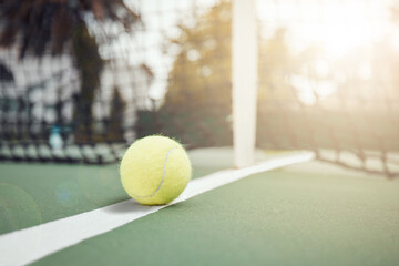 Poster - Closeup of one yellow tennis ball on the floor after hitting a net during a game on a court. Still life ball on a line during a competitive sports match in a sports club. Losing by touching the net