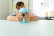 © Sarah Rypma - Young child squeezing blue slime in sensory play therapy