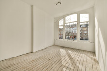An Empty Room With White Walls And Wood Flooring, Looking Out Onto The Street From One Corner To The Other Generative AI