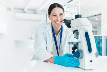Wall Mural - im nearing the end of my research case. portrait of a young scientist using a microscope in a lab.