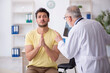 © Elnur - Young male patient visiting old male doctor