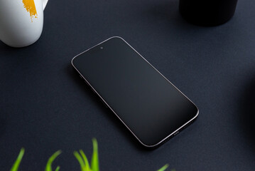 Aufkleber - Blank phone on black table. Plant, coffee mug and pens can beside. Professional business omposition