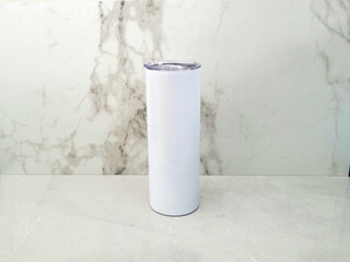 Wall Mural - 20oz blank tumbler against marble backdrop and marble surface.