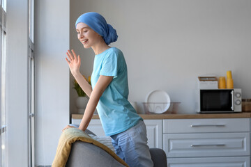 Poster - Teenage girl after chemotherapy on sofa near window in kitchen