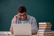 © Elnur - Young male student sitting in the classroom