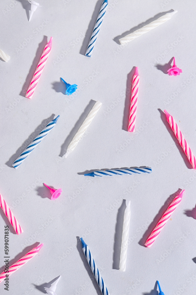 Colorful birthday candles on grey background