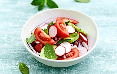 Wall Mural - Spring tomato and cucumber salad with radishes and mint leaves