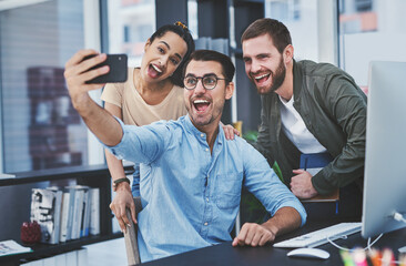 Poster - Making memories with the most amazing team. a group of designers taking selfies together in an office.