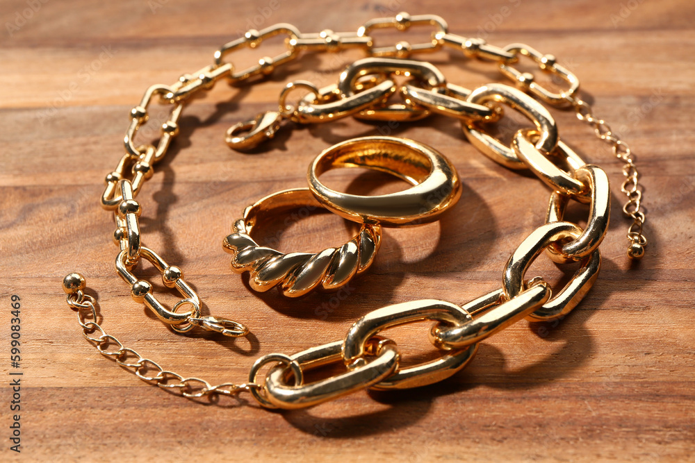 Beautiful rings and bracelets on wooden background