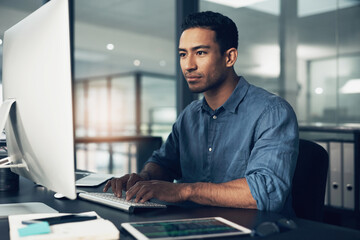 Fototapete - Never mind good, I demand great. a man using a computer in a modern office.