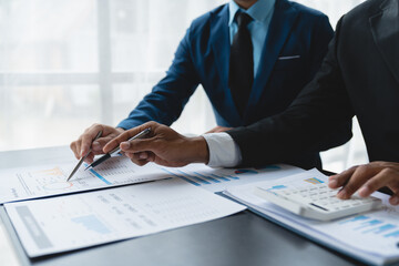 Wall Mural - Modern business people meeting with startup projects pointing to discussion calculations and analysis Charts and graphs of finance, business and accounting data. teamwork concept.