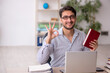© Elnur - Young male employee student working in the office