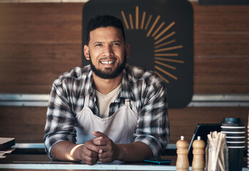 Wall Mural - Craving pizza. a handsome young man standing alone inside his restaurant during the day.