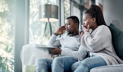 Canvas Print - Who doesnt love a good old soapie now and then. a young couple using a laptop together on the sofa at home.