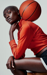 How do you handle the ball. Studio shot of an attractive young woman playing basketball against a grey background.