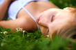 Sleeping beauty. an attractive young woman lying on the grass with her eyes closed.