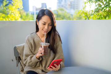 Sticker - Woman use smart phone at cafe with her coffee