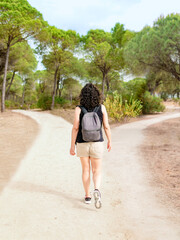 Woman choosing a path in a forest. Concept of decision making in life.