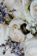 Gold and black wedding rings in bouquet