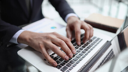 businessman finger typing on computer keyboard in office