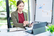© ND STOCK - Young successful employee business woman 20s in casual shirt sit work at white office desk with pc laptop point index finger aside on workspace area on office background studio portrait