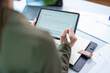 © ND STOCK - Young successful employee business woman 20s in casual shirt sit work at white office desk with pc laptop point index finger aside on workspace area on office background studio portrait