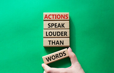 Wall Mural - Actions speak louder than Words symbol. Wooden blocks with words Actions speak louder than Words. Beautiful green background. Businessman hand. Business and Actions concept. Copy space.