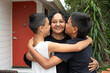 © Austockphoto - Aboriginal family hugging and kissing in backyard