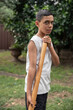 © Austockphoto - Young Aboriginal boy playing a didgeridoo in the backyard