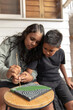 © Austockphoto - Aboriginal girl and boy dot painting together