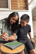 © Austockphoto - Aboriginal girl and boy dot painting together