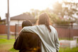 © Austockphoto - Two young Aboriginal women walking together arms around each other