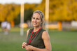 © Austockphoto - fit woman in her thirties on playing field with whistle