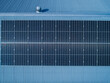 © Austockphoto - Row of solar panels on tin roof seen from aerial view