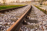Fototapeta  - New railway rails on sleepers at a freight railway station