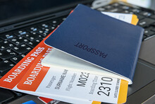 Two Boarding Pass With A Passport On A Laptop Keyboard.