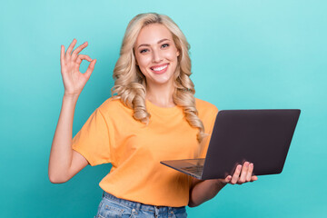 Canvas Print - Photo of cute confident lady dressed orange t-shirt showing okey gesture texting modern gadget isolated teal color background