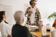 © Jacob Lund - Business manager leading a meeting in a boardroom