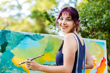 Portrait Of Young Australian Artist Beside Painting Outdoors