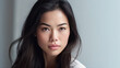 © MarijaBazarova - Portrait of Glamour Asian Woman Model looking straight on white background. Copy space. Generated Ai