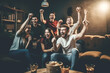 © Jasmina - Sport fans watching game on TV, cheering and celebrating victory, Generative ai